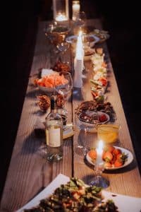 a long wooden table with plates of food on it